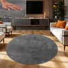 A living room scene with a round rug in the foreground. Produktbild-Vorschau