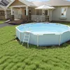 An above-ground swimming pool with a ladder is set up in a grassy backyard next to a house. Náhled obrázku produktu