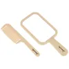 A beige comb and hand mirror set on a white background. Produktbild-Vorschau
