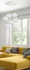 A modern living room with a yellow sectional sofa and a multi-light pendant lamp. Produktbild-Vorschau