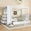 A white canopy bed with integrated storage and a side cabinet, set up in a child's bedroom. Produktbild-Vorschau