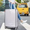 A person is pulling a suitcase covered by a transparent protective cover across a street. Anteprima dell’immagine prodotto