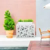 An outdoor patio scene with a modern air conditioner cover, a potted plant, and a chair. Produktbild-Vorschau