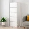 A tall, white cabinet with five doors is shown next to a potted plant and a couch. Voir les images du produit