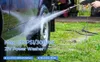 A person is using a cordless pressure washer to clean a car tire and wheel. Produktbild-Vorschau