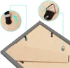 Close-up view of the back of a picture frame, showing hanging hardware and instructional diagrams. Produktbild-Vorschau