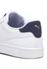 A close-up view of the heel and side of a white Puma sneaker with navy and gold accents. Produktbild-Vorschau