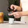 A person is preparing coffee using an espresso machine. Voir les images du produit