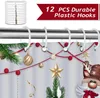 A Christmas-themed shower curtain with hooks hanging on a shower rod. Produktbild-Vorschau