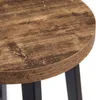 A close-up view of the wooden top of a stool with black metal legs. Produktbild-Vorschau