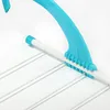 Close-up of a turquoise and white clothes drying rack. Produktbild-Vorschau