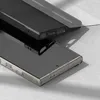 A close-up shot of two phone cases, one black and one clear, on a light gray and white surface. Produktbild-Vorschau