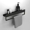 A black bathroom shelf with a towel bar, holding toiletries and a towel. Anteprima dell’immagine prodotto
