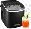 A black ice maker with a clear lid filled with ice cubes, next to a glass of iced beverage. Náhled obrázku produktu