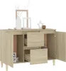 A light brown wooden sideboard with two doors and two drawers, decorated with a vase, a framed picture, and a decorative star. Náhľad obrázku produktu