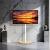 A TV stand with a TV displaying a sunset is shown in a modern room with marble walls. Produktbild-Vorschau