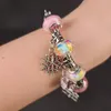 A close-up of a bracelet with charms on a person's wrist. Náhled obrázku produktu