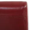 A close-up view of the stitching and texture of a red-brown leather chair. Náhled obrázku produktu
