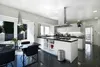 A modern, sleek kitchen with a dining area. Podgląd zdjęcia produktu