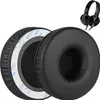 A pair of black ear pads for headphones, with a pair of black headphones in the background. Produktbild-Vorschau