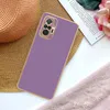 A purple phone case is placed on a straw hat, next to a book and a pink lace fabric. Produktbild-Vorschau