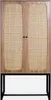 A wooden cabinet with rattan inserts on the doors, standing on a black metal base. Produktbild-Vorschau
