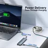 A laptop connected to a USB-C hub, which is also connected to a power adapter, illustrating power delivery. Produktbild-Vorschau