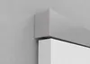 A close-up view of a silver door hardware fitting mounted on a white door, against a textured gray wall. Náhled obrázku produktu
