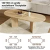 An oval wooden dining table with two pedestal legs, shown in a dining room setting with a rug underneath. Text overlays describe the table's dimensions and seating capacity. Náhľad obrázku produktu
