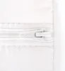 A close-up view of a white zipper on a white quilted fabric. Produktbild-Vorschau
