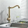A vintage-style kitchen faucet is shown in a kitchen sink setting, with a glass of water and some produce nearby. Náhľad obrázku produktu