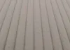 A close-up view of a textured fabric with vertical ribbed lines. Anteprima dell’immagine prodotto
