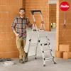 A man stands next to a ladder in a construction site. Náhľad obrázku produktu