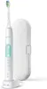 A white electric toothbrush with a charging base and a white travel case, presented against a white background. Náhľad obrázku produktu