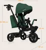 A green and black tricycle with dimensions indicated by measurement lines and text. Produktbild-Vorschau