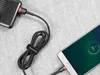 A black and red Baseus micro USB cable is charging a smartphone and a power bank. Náhled obrázku produktu