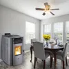 A dining room with a pellet stove and a dining table set for a meal. Anteprima dell’immagine prodotto