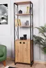 A tall, narrow bookshelf with a wooden cabinet at the bottom, set against a white wall with a green chair and a plant visible. Produktbild-Vorschau