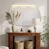 A console table with decorative items and a large mirror above it. Produktbild-Vorschau