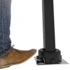 A person's foot in a brown shoe is stepping on a mechanism attached to a black awning pole. Produktbild-Vorschau