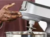 A person's hand with flour on it is shown adjusting a Kenwood stand mixer. Voir les images du produit