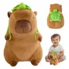 A collage of images showing a plush capybara toy with a turtle backpack, a close-up of the toy's face, and a baby holding a smaller version of the toy. Produktbild-Vorschau