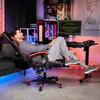 A man relaxing in a gaming chair in a room with a computer setup. Náhled obrázku produktu