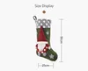 A Christmas stocking with a gnome decoration, shown with size indicators. Náhľad obrázku produktu