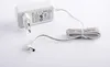 A white power adapter with a coiled cable and a DC connector on a white background. Produktbild-Vorschau