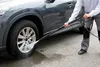 A person is pressure washing a car wheel. Produktbild-Vorschau