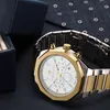 A close-up shot of a Maserati watch with a gold and silver band and a white face, placed next to a dark blue watch box. Produktbild-Vorschau