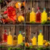 A collage of four images showing glass bottles filled with colored liquids, some with oranges and moss, on wooden surfaces. Produktbild-Vorschau