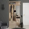 A hallway furniture set with a mirror, coat hooks, shelves, and a drawer, next to a door and a chair. Náhled obrázku produktu