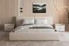 A bedroom scene featuring a bed, nightstands, and wall art. Produktbild-Vorschau